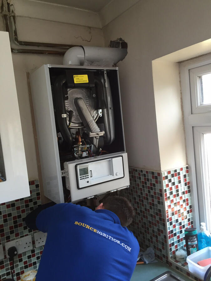 Expert plumber from Source Ignition servicing a boiler