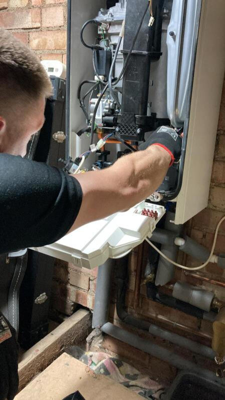 Gas Safe registered plumber working on boiler repair